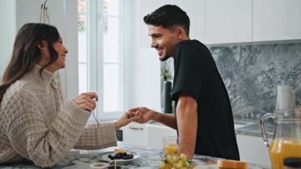 Tender man kissing woman hand at luxury interior. Romantic couple bonding at kitchen closeup. Smiling lady touching noses with husband. Positive lovers enjoying each other flirting at morning together - Footage, Video