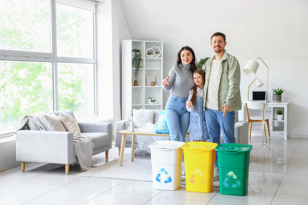 Family with recycle bins at home - 写真・画像