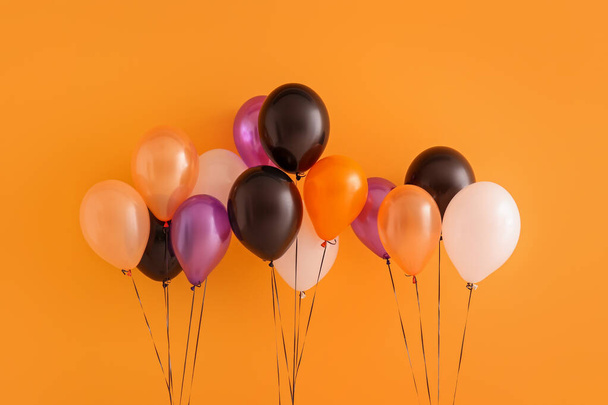 Different Halloween balloons on orange background - Photo, Image
