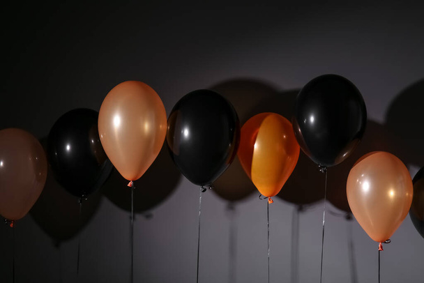 Different Halloween balloons on dark grey background - Фото, зображення