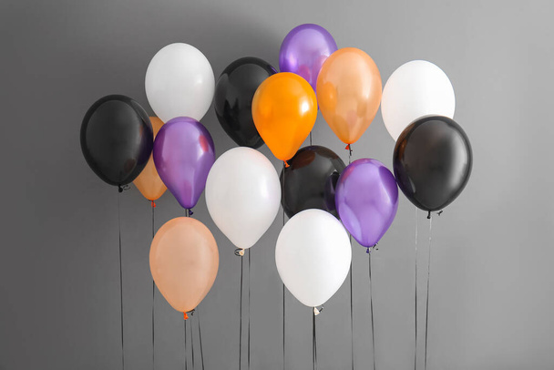 Different Halloween balloons on grey background - Photo, Image