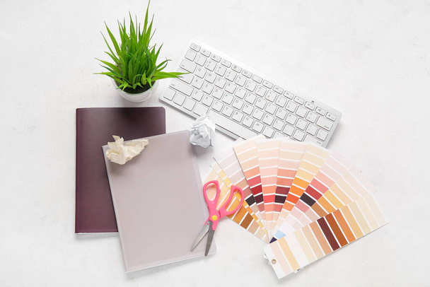Color palettes, PC keyboard, notebooks and scissors on light background - Photo, image