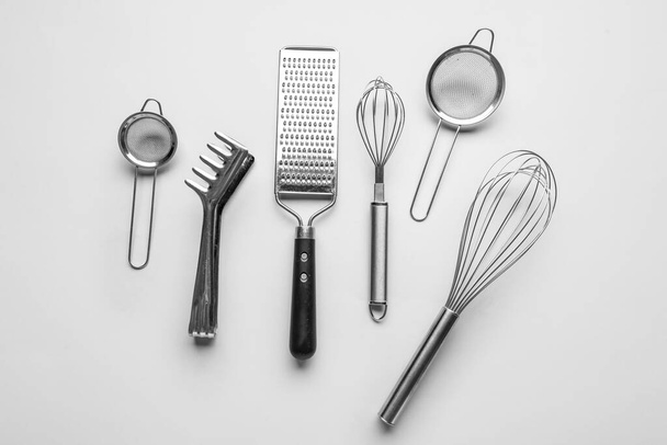 Set of stainless steel kitchen utensils on light background - Foto, Imagem