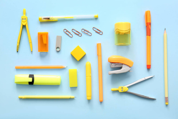 Different school stationery on blue background - Foto, afbeelding