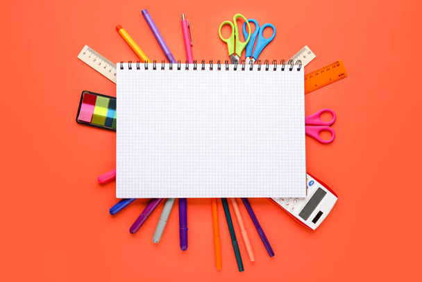 Composition with blank notebook and different stationery on color background - Фото, зображення