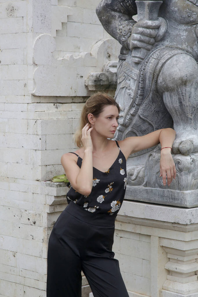 Elegante mujer turista de moda posando junto al templo blanco balinés - Foto, imagen