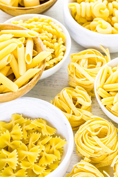 Variety of yellow dry pasta - Photo, image