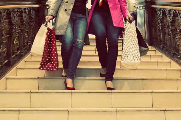 Two unrecognisable young female friends enjoying a day out shopping - Фото, изображение