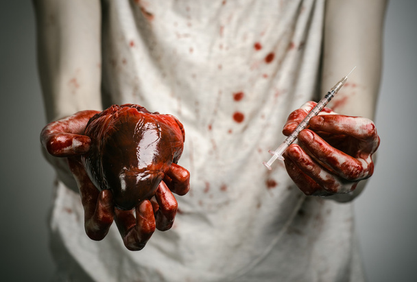 Social advertising and the fight against drug addiction: bloody hands addict holding syringe and bloody human heart - Foto, Imagen