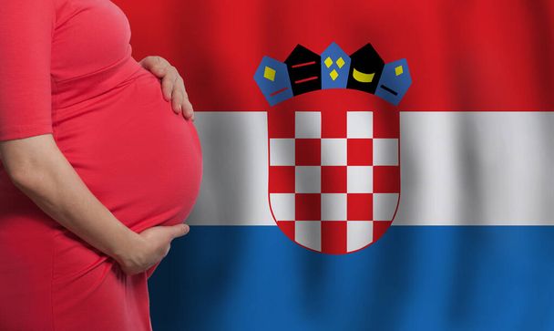 クロアチアの背景の旗にクロアチアの妊婦腹 - 写真・画像