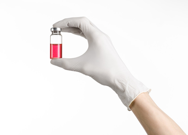 Medical theme: doctor's hand in a white glove holding a red vial of liquid for injection isolated on white background - Zdjęcie, obraz