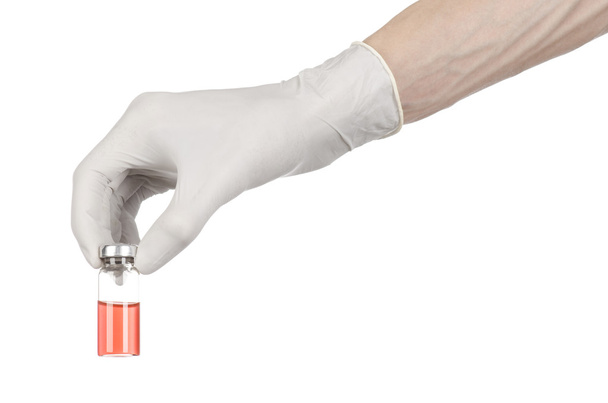 Medical theme: doctor's hand in a white glove holding a red vial of liquid for injection isolated on white background - Photo, Image