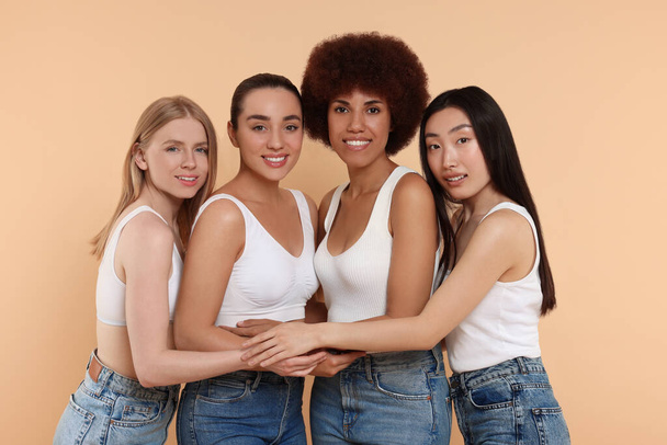 Group of beautiful young women on beige background - Fotografie, Obrázek