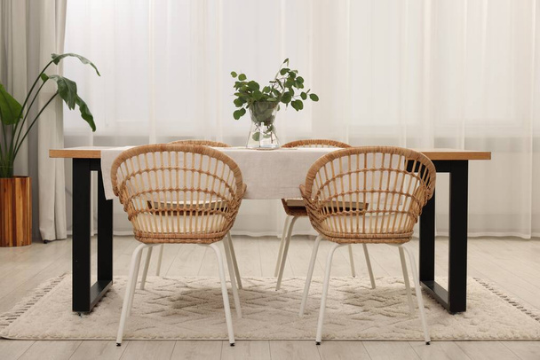 Stylish dining room with cozy furniture and plants - Zdjęcie, obraz