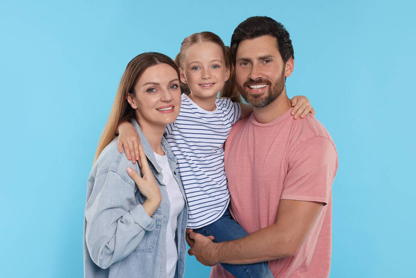 Happy family together on light blue background - Foto, afbeelding