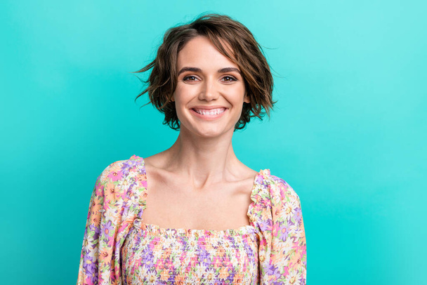 Photo of gorgeous pretty satisfied woman with short hairstyle wear colorful dress toothy smiling isolated on turquoise color background. - Foto, afbeelding