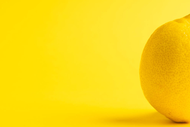 Close up of lemon and copy space on yellow background. Fruit, exotic fruit, food, freshness and colour concept. - Photo, Image