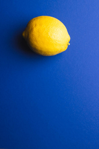 Close up of lemon and copy space on blue background. Fruit, exotic fruit, food, freshness and colour concept. - Foto, afbeelding