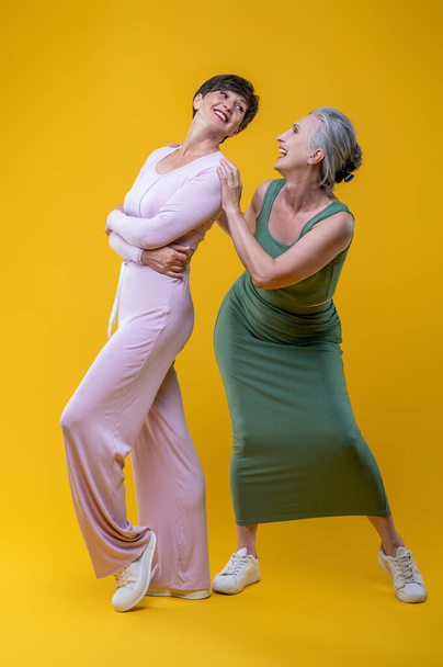 Femininity. Two good-looking senior women feeling excited - Fotó, kép