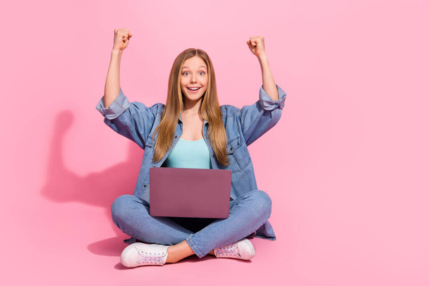 Photo of cheerful charming girl wear jeans outfit sit raise hands fist celebrate black friday discount isolated on pink color background. - Fotoğraf, Görsel