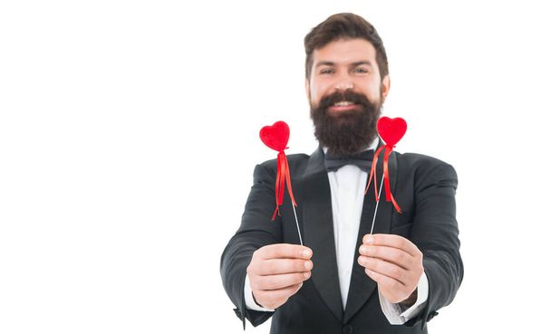 Gift with love. tuxedo man on formal event. special occasion party. male groom on wedding ceremony. going to make proposal. bearded man red hearts. love symbol. happy valentines day. love is blind. - Foto, afbeelding