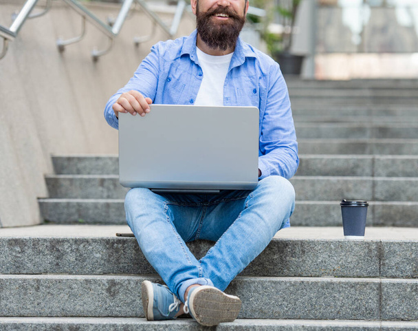 cropped view of man freelancer has video call on laptop. man freelancer has video call outside. man freelancer has video call at coffee break. man freelancer has video call outdoor. - 写真・画像