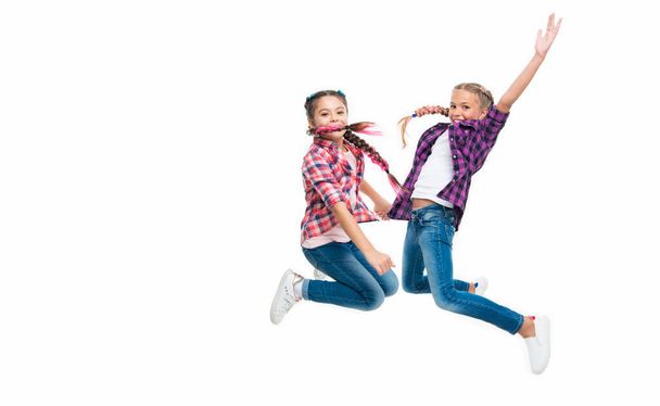 girls friends having fun and jumping. friendship of two children. happy girls sisterhood. children have fun together. bond of sisterhood and friendship. Sisters by heart. copy space. - Foto, Imagem