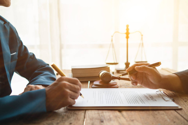 contract of sale was placed on the table in the lawyer office because the company hired the lawyer office as a legal advisor and drafted the contract so that the client could sign the right contract. - Photo, Image
