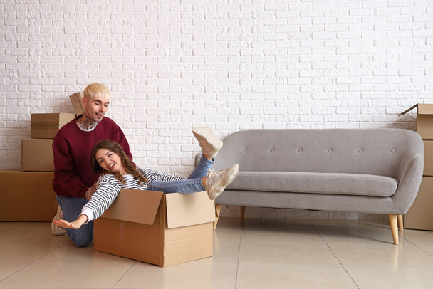 Young couple having fun in room on moving day - Photo, Image