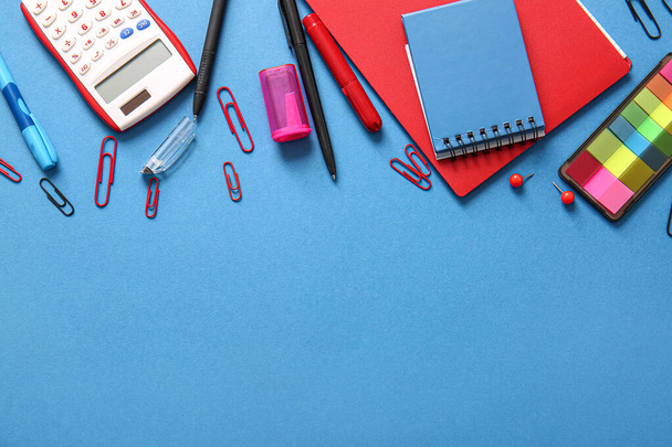 Different school stationery and notebooks on blue background - Photo, Image