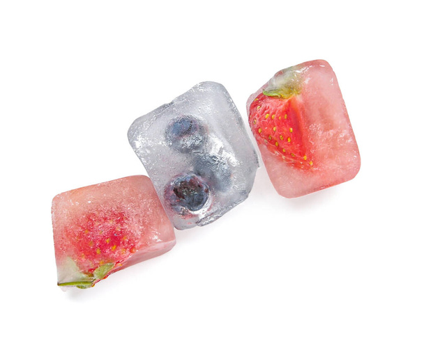 Frozen berries in ice cubes on white background - Photo, Image