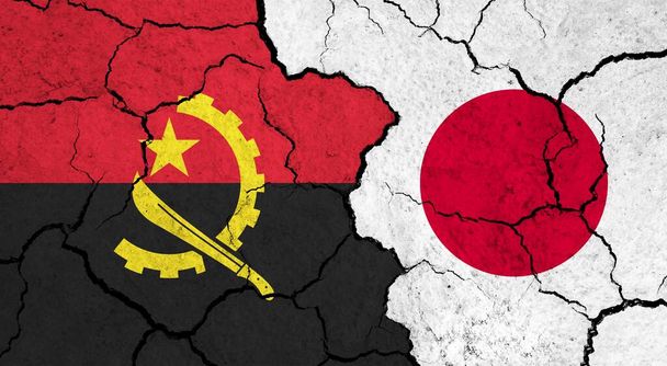 Flags of Angola and Japan on cracked surface - politics, relationship concept - Photo, Image