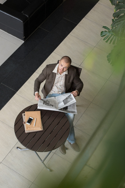 Businessman reading newspaper - Фото, изображение