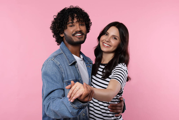International dating. Happy couple dancing on pink background - Fotó, kép