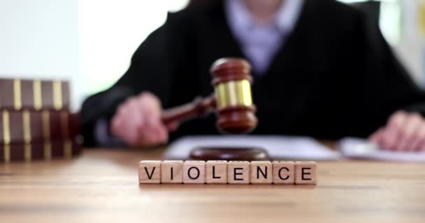 Word violence on wooden cubes judge in courtroom closeup. Sexual abuse in family - Footage, Video