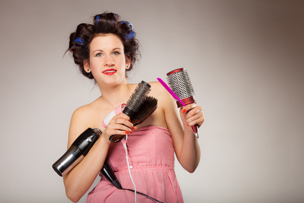 funny girl styling hair holds many accessories - Valokuva, kuva