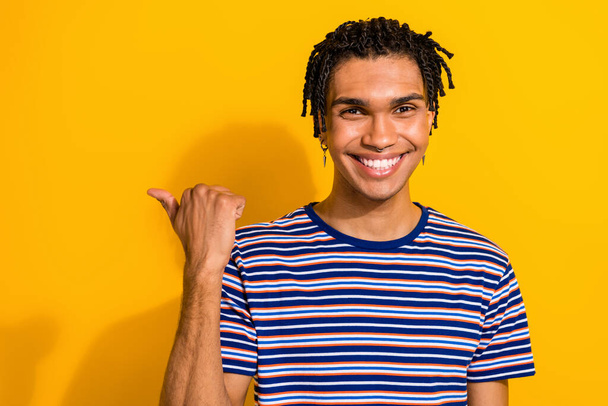 Photo of positive cool man wear stylish outfit clothes arm demonstrate empty space showing cool offer isolated on yellow color background. - Foto, Imagem