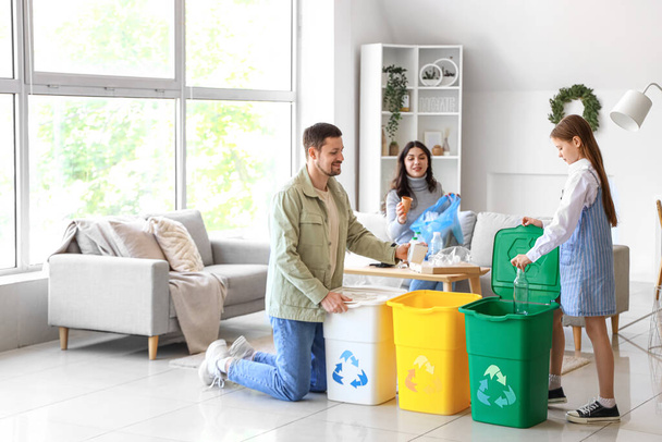 Family sorting garbage in recycle bins at home - Photo, Image
