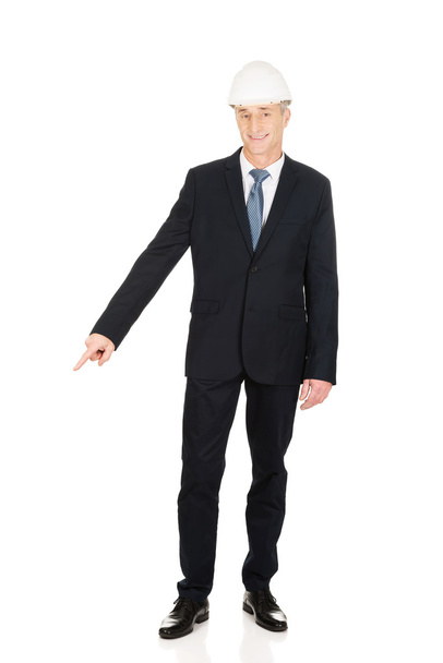 Smiling businessman pointing down - Photo, image