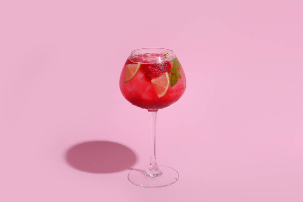 Glass of fresh raspberry mojito on pink background - Photo, Image