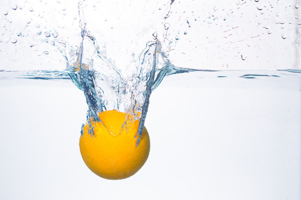 orange splash in water - Фото, зображення