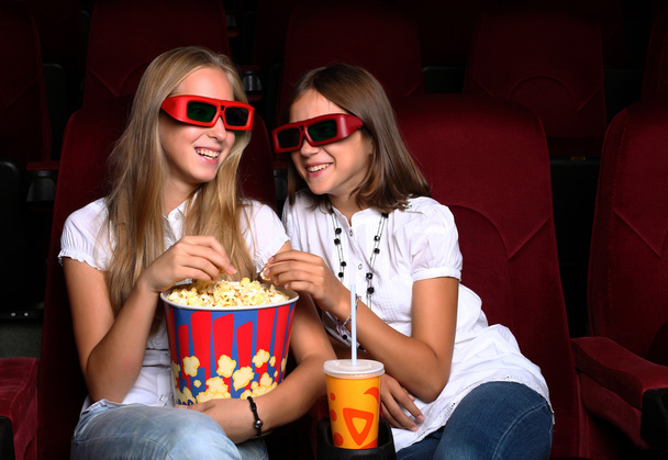 Two young girls watching in cinema - Fotoğraf, Görsel