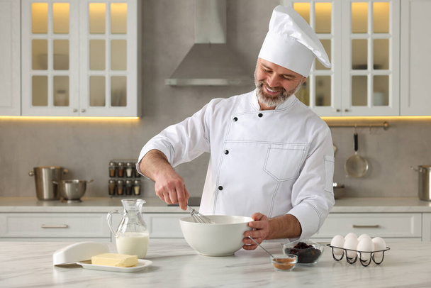 Professional chef making dough at white marble table in kitchen - Fotografie, Obrázek