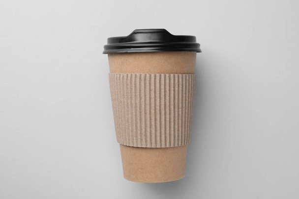 One paper cup on light grey background, top view. Coffee to go - Фото, изображение