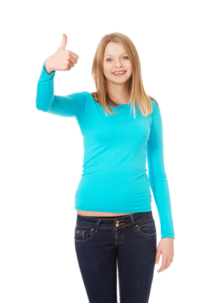 Female student showing thumb up - Fotó, kép