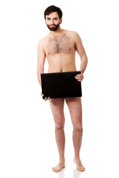 Shirtless man holding laptop. - Fotografie, Obrázek