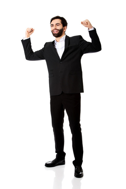 Businessman making fists in a winner gesture. - Photo, image