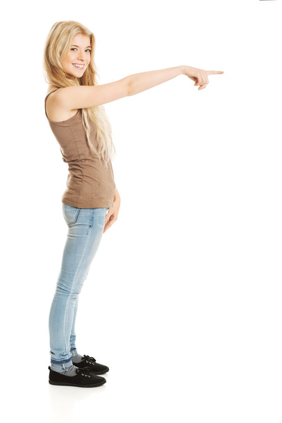 Student woman pointing on the right - Foto, imagen