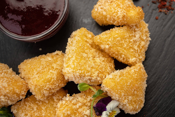 golden cheese nuggets on slate with sweet sauce - Photo, Image