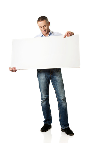 Handsome man holding an empty banner - Photo, image